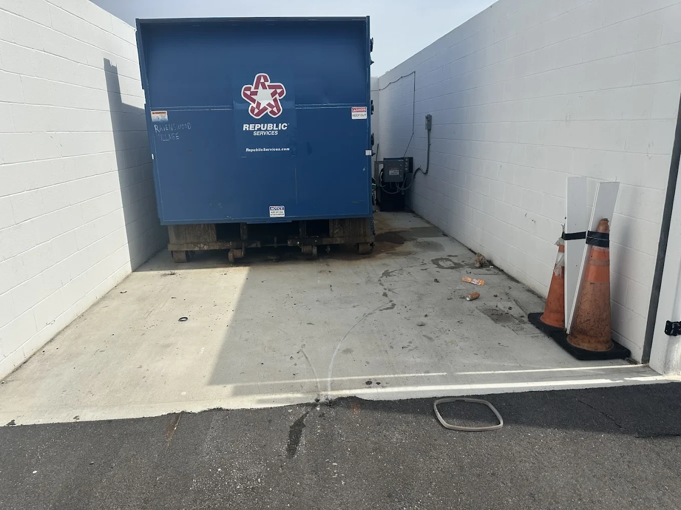 Same dumpster enclosure cleared and swept after the MLR crew finished