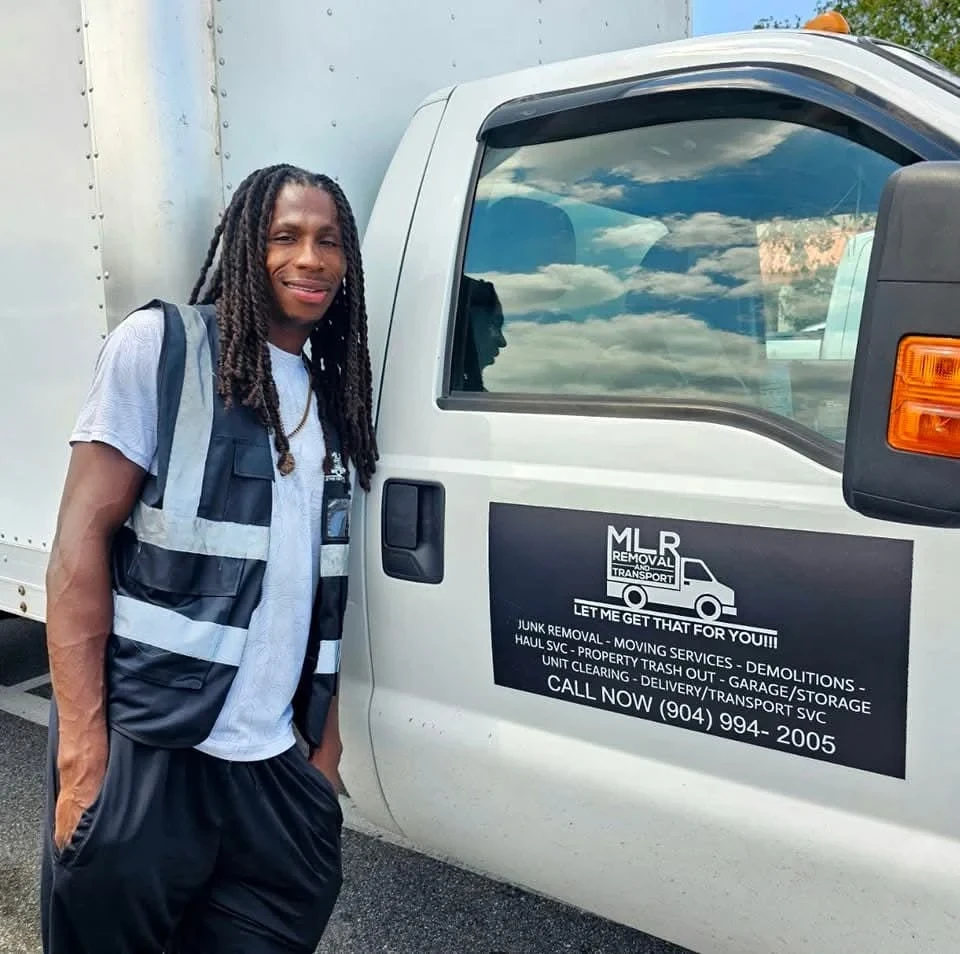 Owner of MLR Junk Removal and Transport standing beside the company truck in Jacksonville, Florida